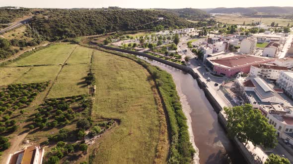 Backwards flying aerial along the Arade river in Silves in the Portuguese region of Algarve