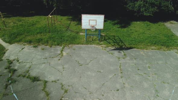 Old Basketball Backboard. Made From Boards. Peeling Paint And A Battered Basket