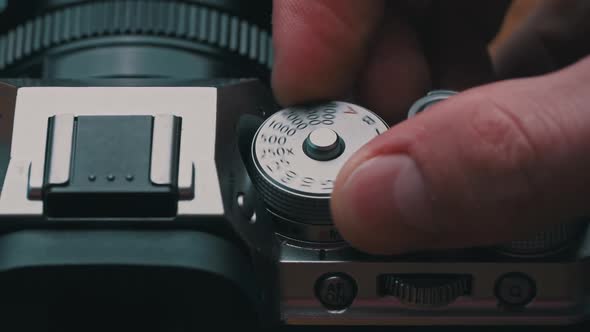 Man's Hands Turn the Aperture Wheel on a Vintage Camera Closeup