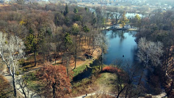 Arial Drone View Flight Over Lake in Park on Sunny Autumn Day
