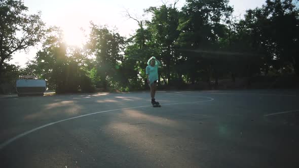 Beautiful Young Girl with Green Hair Riding on Longboard During Sunset Slow Motion