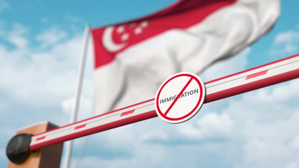 Barrier Gate with No Immigration Sign Opened at Flag of Singapore