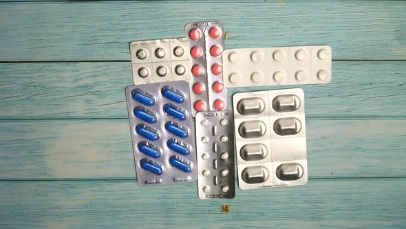 Protective Mask and Pills on Wooden Background Stop Motion Animation, Coronavirus Pandemic alt