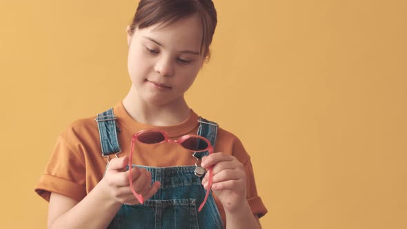 Portrait of Little Girl with Down Syndrome in Funny Sunglasses