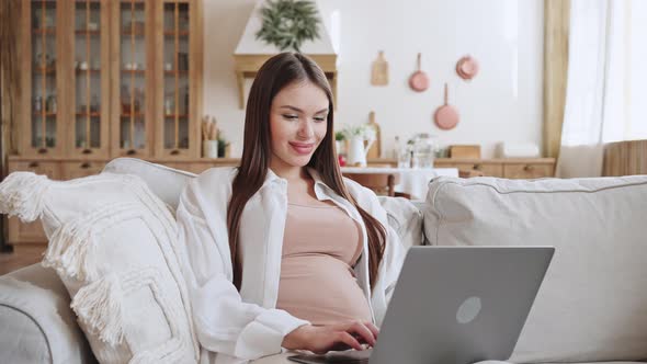 Happy Pregnant Woman Works Online Using Laptop at Home