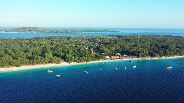 Wide drone island view of a sandy white paradise beach and blue sea background in colorful 