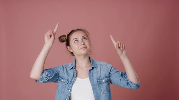 Caucasian teenage girl pointing on copy space. Shot with RED helium camera in 8K.