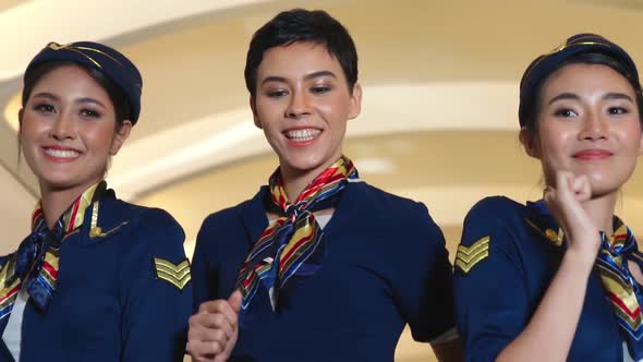 Cabin Crew Dancing with Joy in Airplane