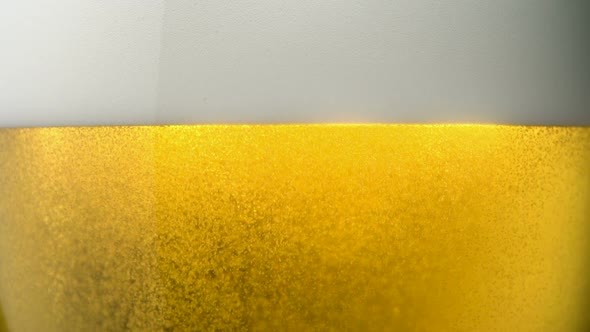 Extreme close-up beer foam and bubbles, Slow Motion