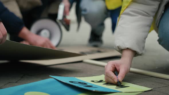 Caucasian woman preparing cardboard banners for manifest against Ukrainian war. Shot with RED helium