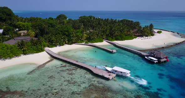 Wide angle flying copy space shot of a white sand paradise beach and aqua turquoise water background