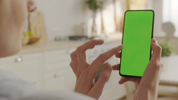 Back View of Woman at Phone with Green Screen for Copy Space