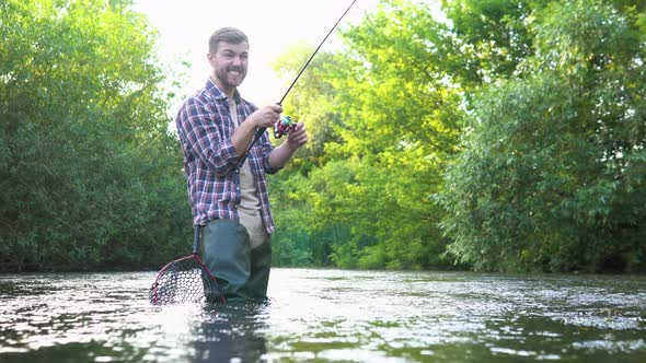 Fisherman with Fishing Rod on the River