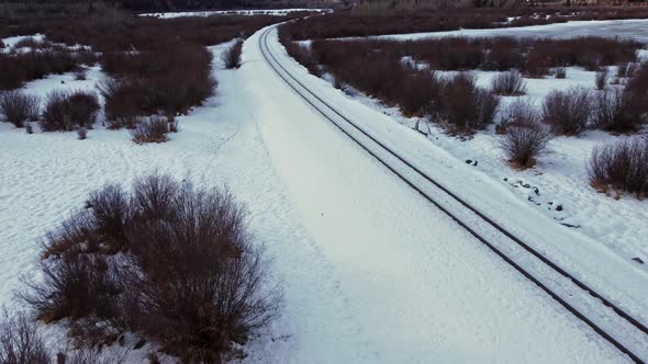 Railway empty in winter snow flyover