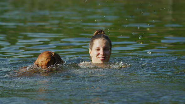 Girl swimming with her dog
