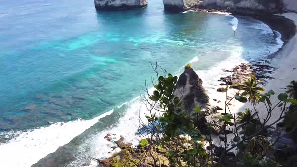 Beautiful Tropical Beach Aerial - a Bird's Eye View of Ocean Waves Crashing Against an Empty Beach