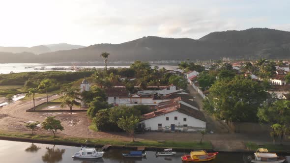 Aerial View Over Colorful Houses In The Town With The Mountains