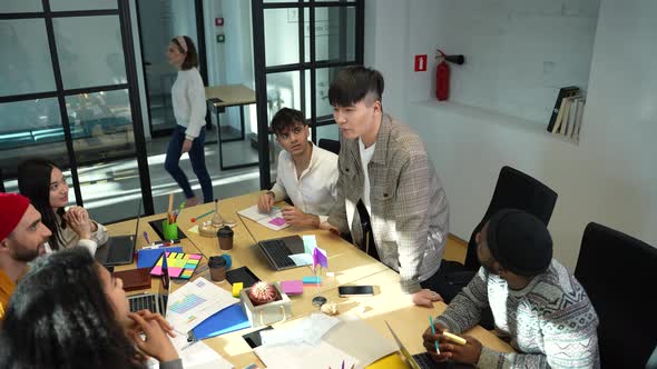 Diverse Coworkers Listening to Team Leader