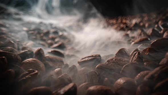 Close Up of Seeds of Coffee. Fragrant Coffee Beans Are Roasted Smoke Comes From Coffee Beans.