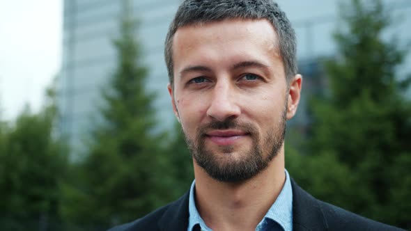 Close-up Slow Motion Portrait of Smiling Male Entrepreneur Outdoors in City Street