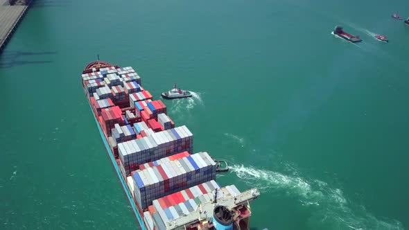 Top view of cargo ship passing the harbor