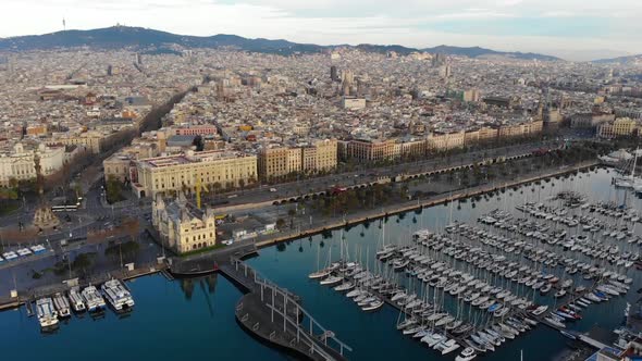 Drone view of Barcelona city and boats, morning