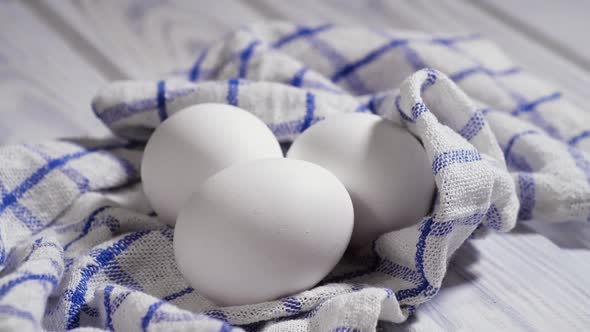 Three Raw Chicken Eggs on the Table Rotating Shot Chicken White Fresh Raw Eggs on a Piece of Cloth