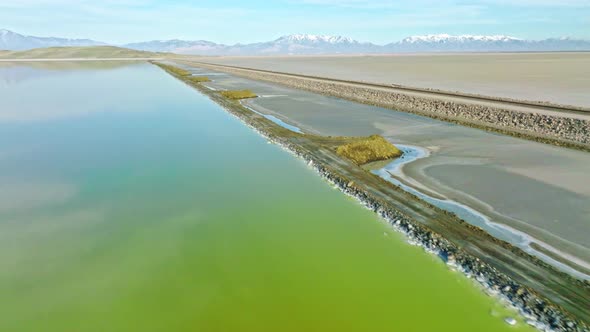 AERIAL - Great Salt Lake with mountain range in the background, Utah, forward tilt up