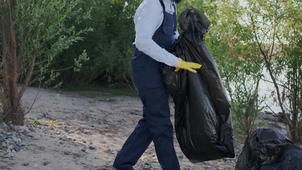 Young Curly Latin American Man Volunteering in Forest or Beachside