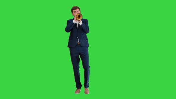 Man in Suit Standing Playing Trumpet on a Green Screen, Chroma Key.