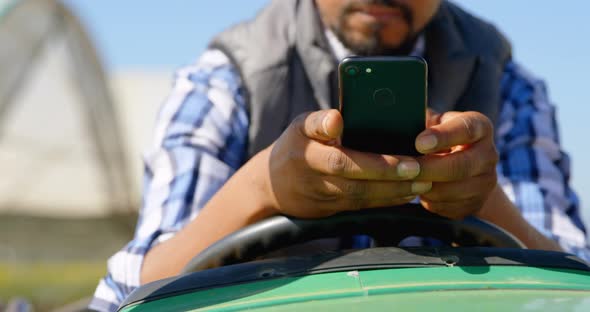 Man using mobile phone in blueberry farm 4k