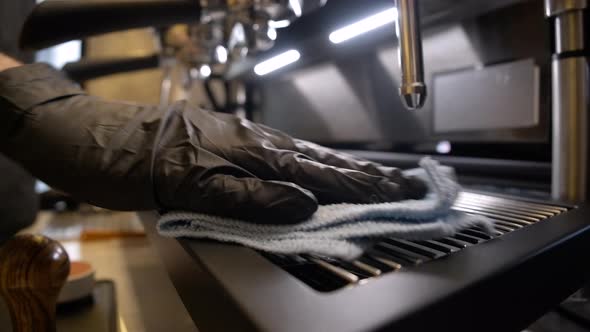 Male Hand Cleaning Coffee Machine with Napkin