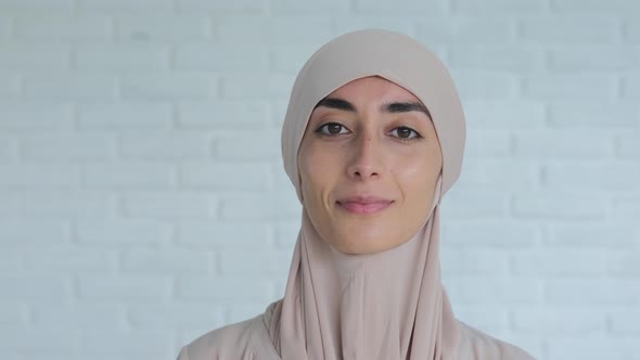 Portrait of Smiling Muslim Woman Wearing Traditional Hijab Head Covering Looking Confidently at