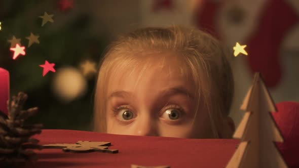 Little Girl Appearing From Under Table, Looking Around, Doing Christmas Pranks