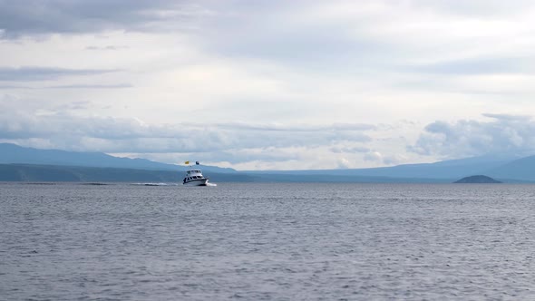 Beautiful landscape shot of a large boat cruising across Lake Taupo in New Zealand.