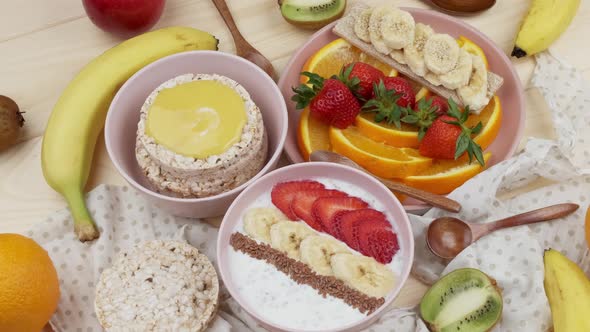 Morning Breakfast with Fruits Yoghurt with Bananas and Strawberries Honey Crisps Fresh Sliced Orange