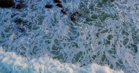 Overhead shot of waves crashing on the rocks on an afternoon in Puerto Plata