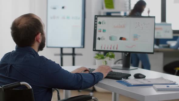 Handicapped Entrepreneur Typing on Computer