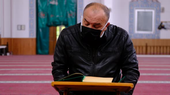 Masked Muslim Reading Quran