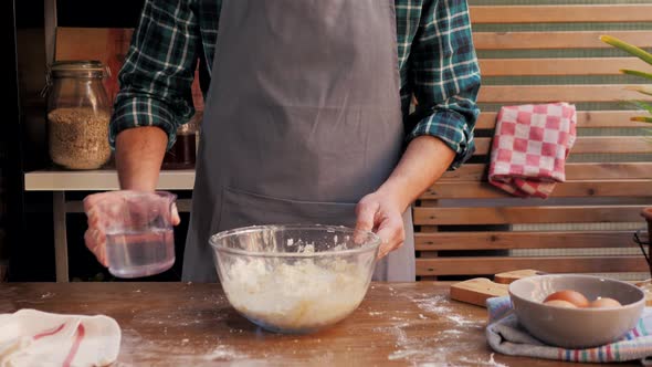 Hands Kneading Raw Dough on Table Flat Lay. Top View on Baker with Empanadas Cooking on Table