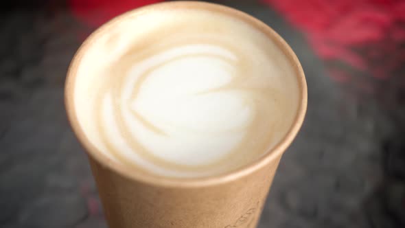 cappuccino in a disposable glass. coffee house.