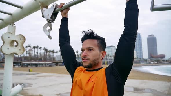 Man training at the beach outdoor gym