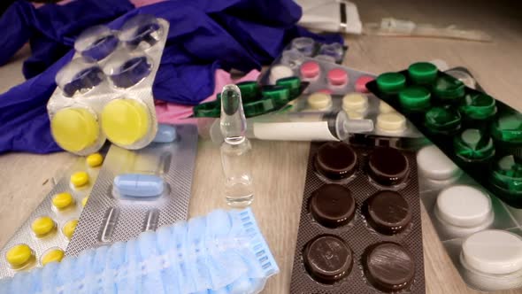 Vaccine in Transparent Vial Stand By Pills Masks and Gloves