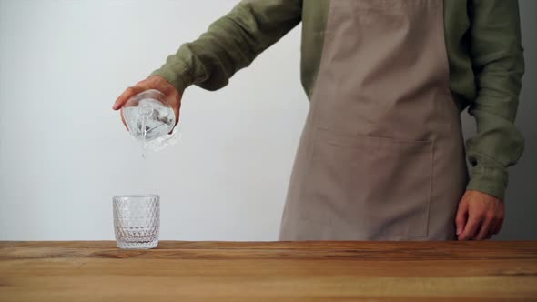 Man pouring water into glass