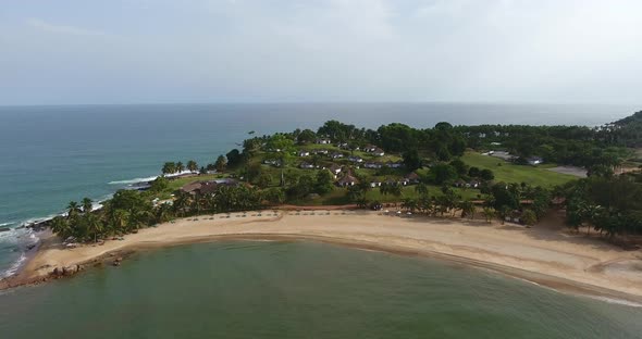 Establishing shot of the beach resort on the tip of Mermaids Bay in Southwest Ivory Coast Africa