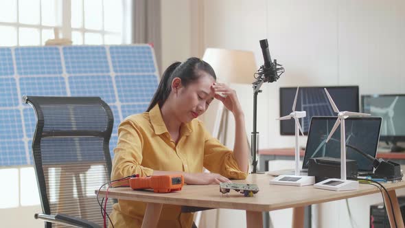 Woman Being Upset Failing Testing The Wind Turbine While Working With Laptop Next To The Solar Cell