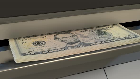 5 US dollar in cash dispenser. Withdrawal of cash from an ATM.