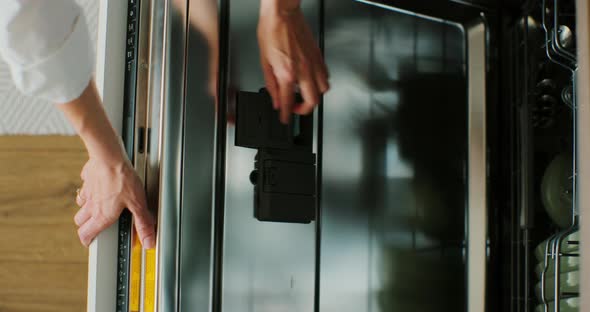 Woman Hands Puts Detergent Dishwasher Tablet in Dishwasher Machine