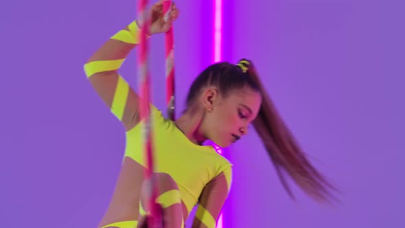 Young Girl Aerial Acrobat Rotates in the Air on a Hoop