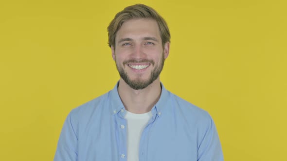 Smiling Young Man on Yellow Background